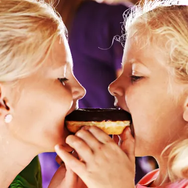 Two children eating a doughnut in the LEGOLAND Restaurant Einstein Cafe