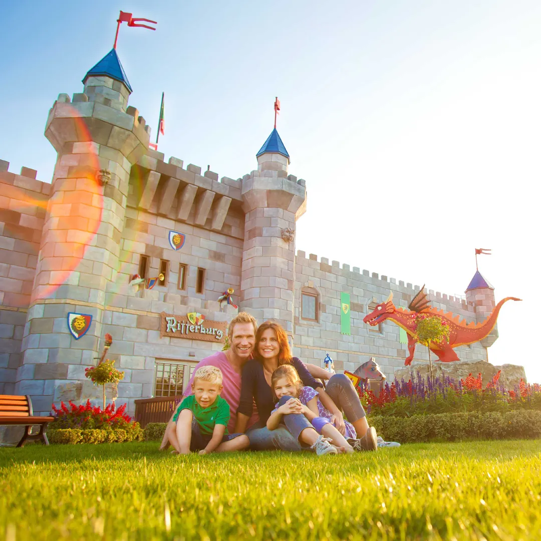 Family in front of the Ritterburg Hotel in the LEGOLAND holiday village