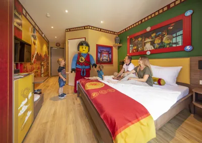 Family on bed in NINJAGO Quarter Room in LEGOLAND Holiday Village