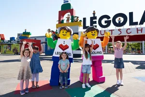 LEGOLAND Boy & LEGOLAND Girl in front of portal with children