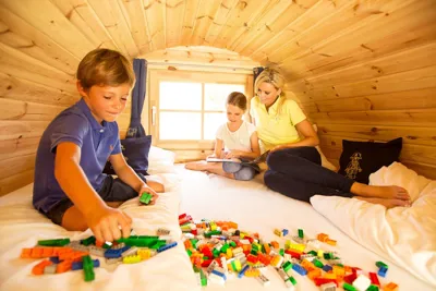 Child plays with LEGO in the LEGOLAND vacation village camping barrel
