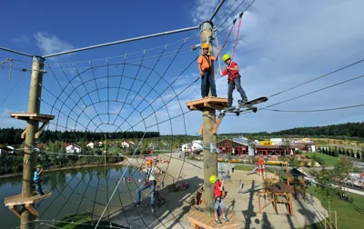 Guests climb in the LEGOLAND Deutschland vacation village high ropes course