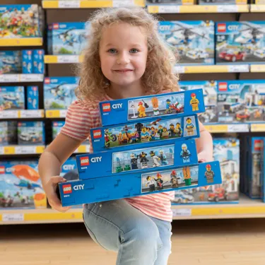 a girl with LEGO building sets in the LEGOLAND City Shop