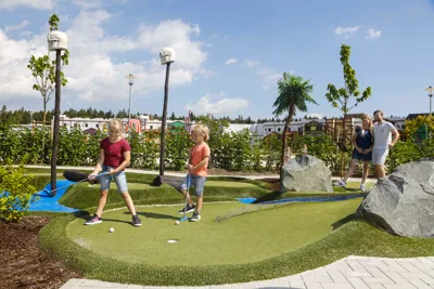 Family on the minigolf course in the LEGOLAND vacation village
